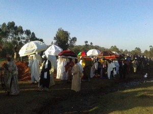 The priests with the rectangular "hats" are carrying the Tabots on their head.  